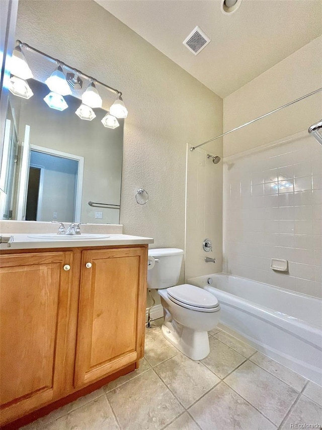 full bathroom featuring tile patterned flooring, toilet, vanity, and tiled shower / bath