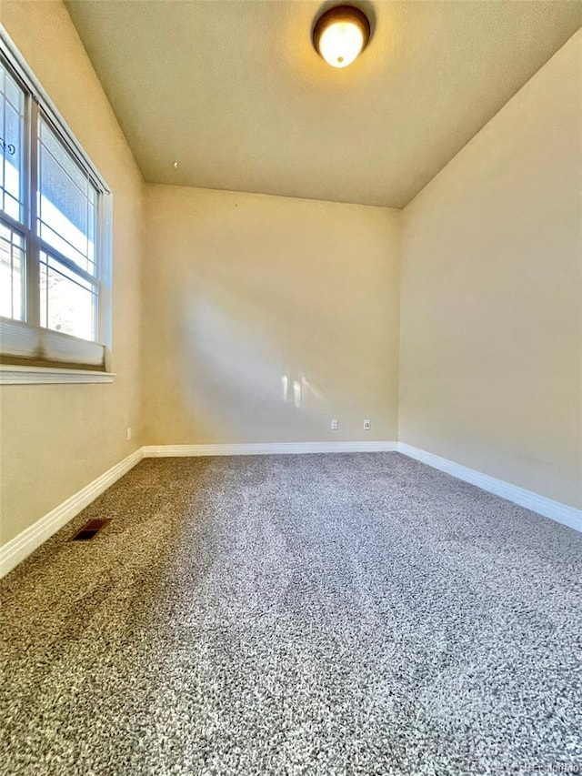 spare room with carpet floors and a textured ceiling