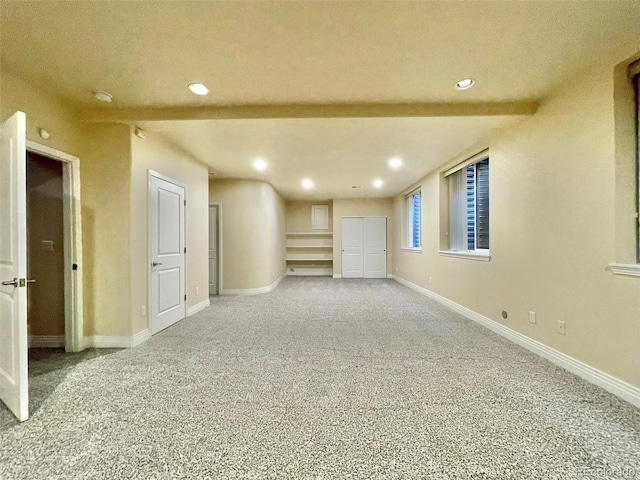 basement featuring carpet flooring and a textured ceiling