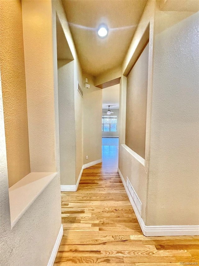 corridor featuring wood-type flooring