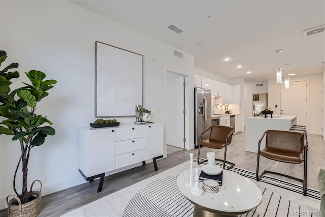 3500 S Corona St Unit 407, Englewood, CO 80113 - living area with light wood-style flooring, baseboards, and recessed lighting