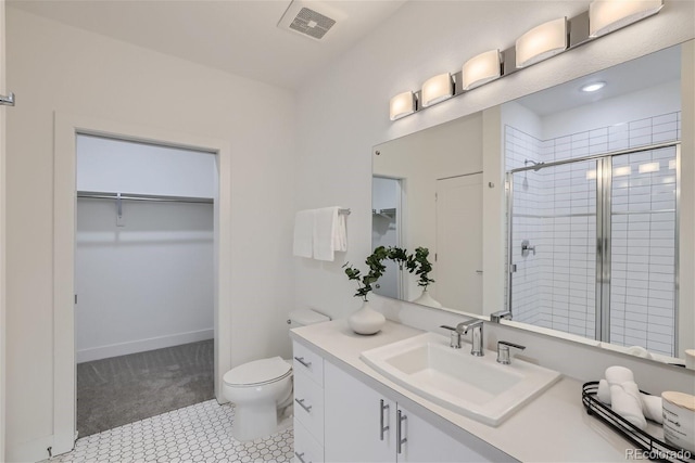 3500 S Corona St Unit 407, Englewood, CO 80113 - bathroom featuring a spacious closet, vanity, toilet, and a stall shower