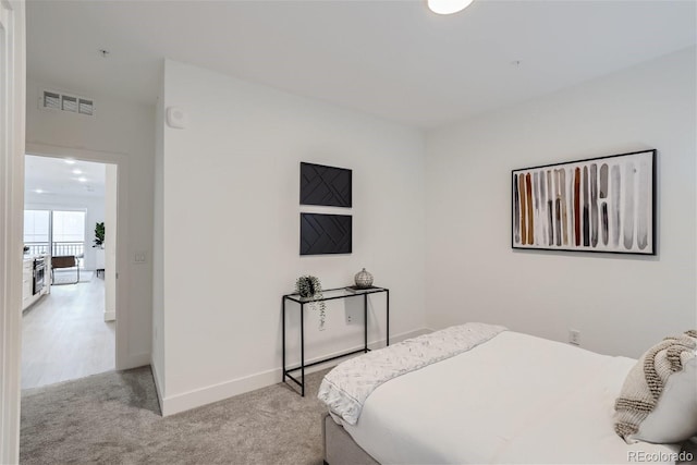 3500 S Corona St Unit 407, Englewood, CO 80113 - bedroom featuring light carpet and baseboards