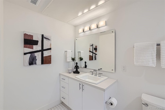 3500 S Corona St Unit 407, Englewood, CO 80113 - bathroom featuring toilet, vanity, and baseboards