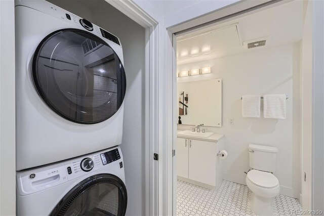 3500 S Corona St Unit 407, Englewood, CO 80113 - washroom with estacked washer and dryer and light tile patterned flooring
