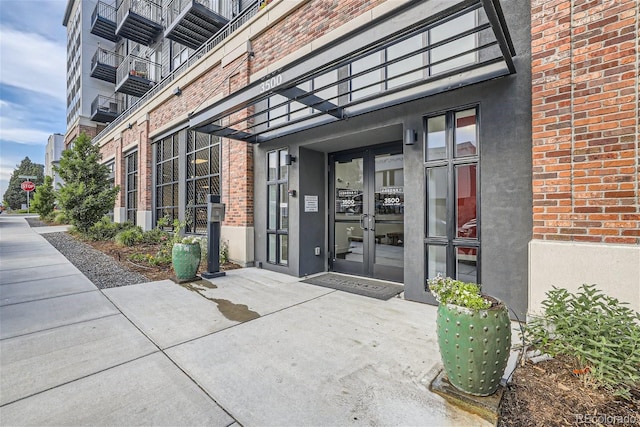 3500 S Corona St Unit 407, Englewood, CO 80113 - property entrance with brick siding, french doors, and stucco siding