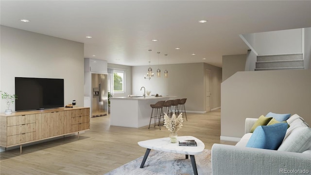 living room with light hardwood / wood-style flooring and sink