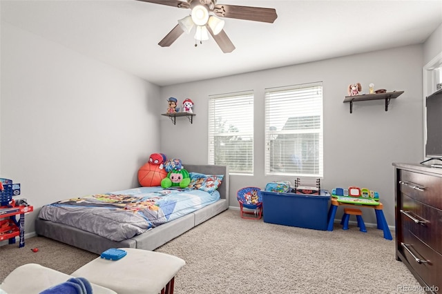 carpeted bedroom with a ceiling fan and baseboards