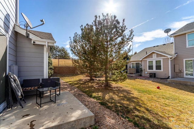 view of yard featuring a patio area, central AC unit, and fence