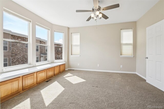 836 Vernon Dr, Central City, CO 80427 - spare room featuring a ceiling fan, baseboards, plenty of natural light, and light carpet