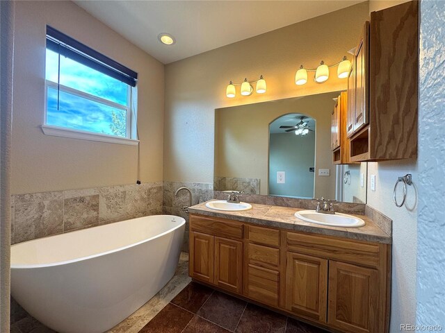 836 Vernon Dr, Central City, CO 80427 - bathroom featuring double vanity, a ceiling fan, a freestanding bath, and a sink