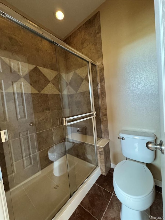 full bath featuring tile patterned flooring, toilet, baseboards, recessed lighting, and a stall shower