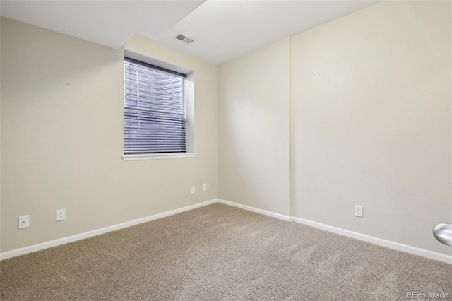 spare room featuring baseboards, carpet, and visible vents