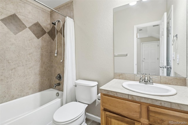 bathroom featuring vanity, a textured wall, shower / bath combination with curtain, and toilet