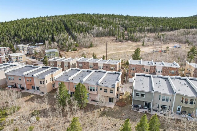 drone / aerial view featuring a wooded view