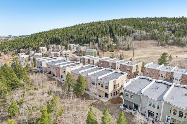 birds eye view of property with a wooded view