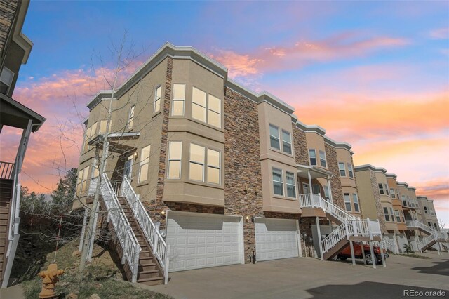 836 Vernon Dr, Central City, CO 80427 - property at dusk with an attached garage, driveway, and stairway