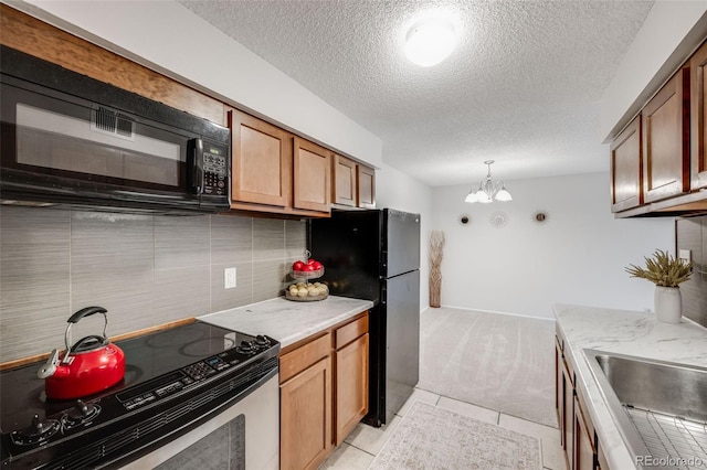 kitchen with black appliances, a textured ceiling, a chandelier, tasteful backsplash, and light carpet