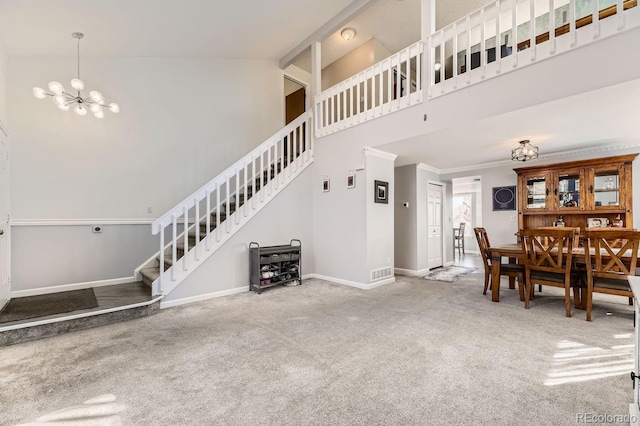 interior space featuring a notable chandelier, ornamental molding, and a high ceiling