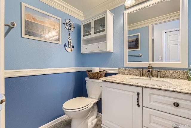 bathroom with ornamental molding, toilet, and vanity