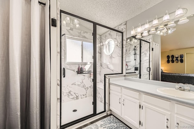 bathroom with walk in shower, vanity, and a textured ceiling