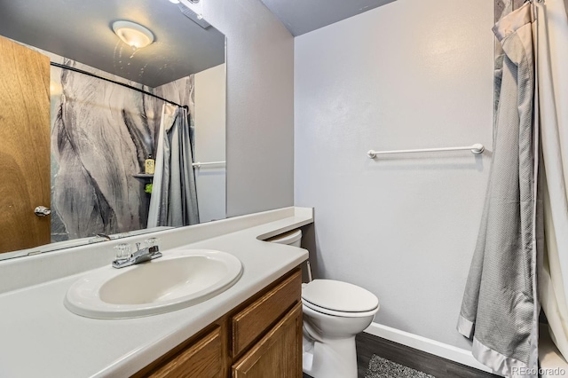 bathroom with vanity, hardwood / wood-style floors, curtained shower, and toilet