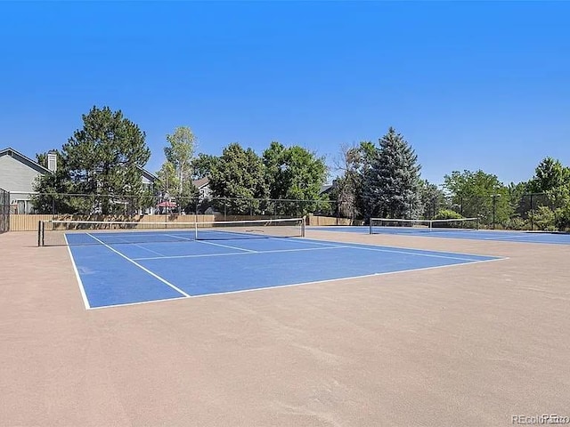 view of tennis court featuring basketball court