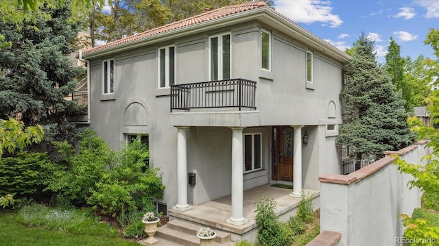 600 Vine St, Denver, CO 80206 - back of house featuring a balcony, stucco siding, and a tiled roof