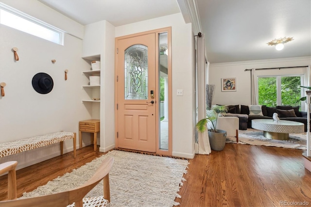 600 Vine St, Denver, CO 80206 - foyer entrance featuring plenty of natural light, wood finished floors, baseboards, and crown molding