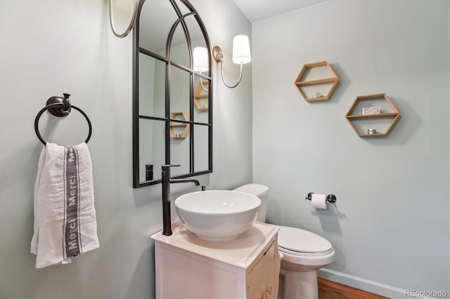 600 Vine St, Denver, CO 80206 - bathroom with vanity, wood finished floors, toilet, and baseboards