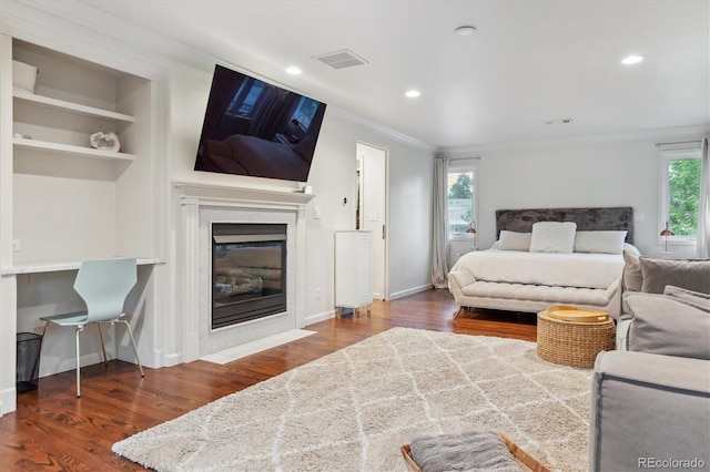 600 Vine St, Denver, CO 80206 - bedroom with wood finished floors, a fireplace with flush hearth, ornamental molding, recessed lighting, and baseboards
