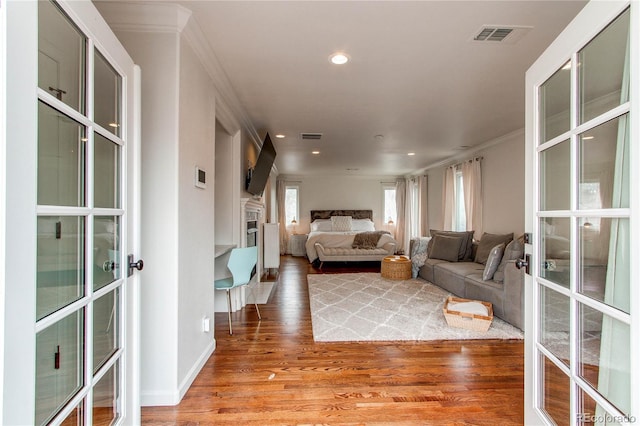 600 Vine St, Denver, CO 80206 - living area with french doors, light wood finished floors, recessed lighting, crown molding, and a fireplace