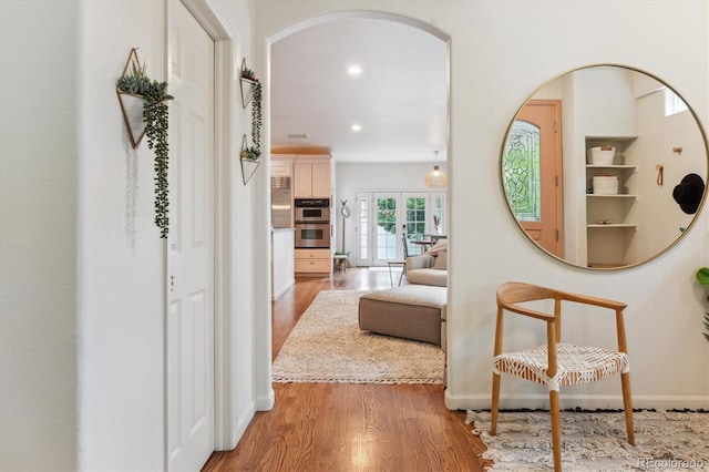 600 Vine St, Denver, CO 80206 - corridor with arched walkways, wood finished floors, baseboards, recessed lighting, and french doors