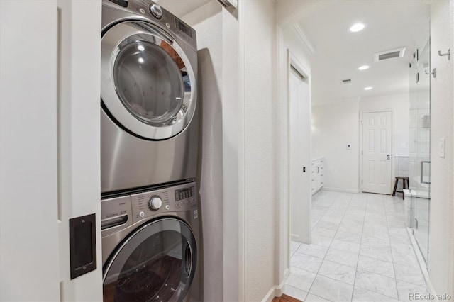 600 Vine St, Denver, CO 80206 - laundry room featuring stacked washer / dryer, crown molding, light marble finish floors, recessed lighting, and baseboards