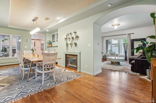 600 Vine St, Denver, CO 80206 - dining area featuring wood finished floors, arched walkways, baseboards, recessed lighting, and a baseboard heating unit