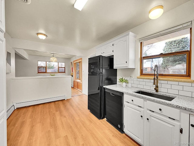 kitchen featuring sink, black appliances, baseboard heating, decorative backsplash, and white cabinets