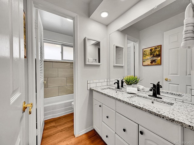 bathroom featuring hardwood / wood-style flooring, vanity, and toilet