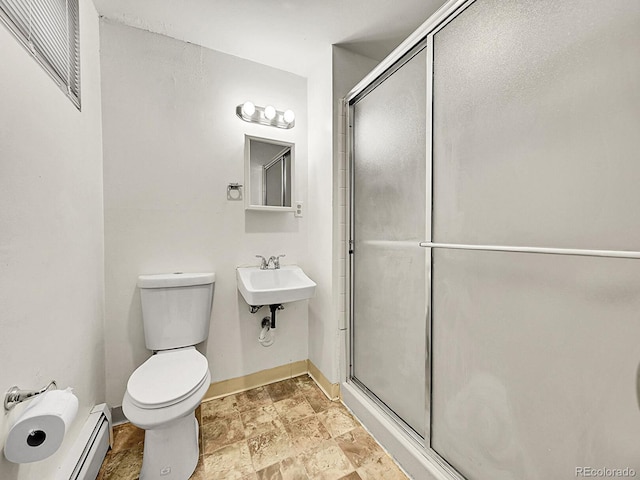 bathroom featuring toilet, an enclosed shower, and a baseboard heating unit