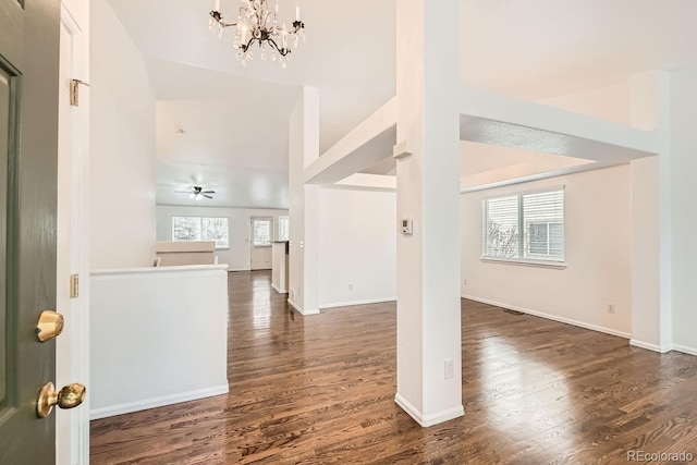 entryway featuring dark hardwood / wood-style flooring, a notable chandelier, and vaulted ceiling