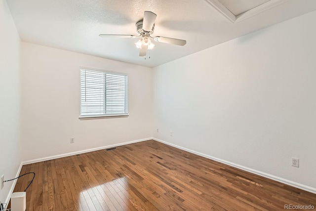 unfurnished room featuring a textured ceiling, wood-type flooring, and ceiling fan