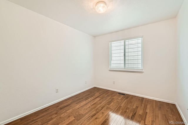 spare room with wood-type flooring