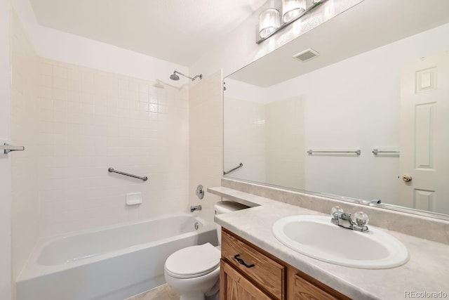 full bathroom featuring vanity, tiled shower / bath, and toilet