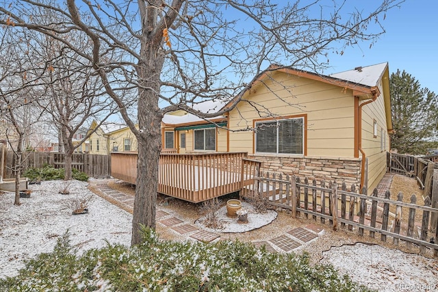 snow covered property featuring a deck