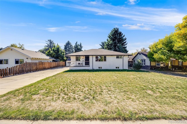 ranch-style home with a front lawn