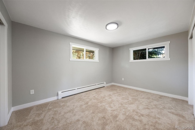 carpeted spare room featuring a baseboard radiator