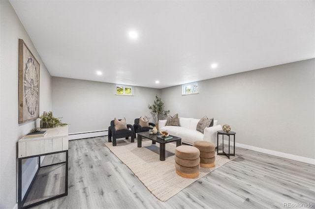 living room with light hardwood / wood-style flooring and a baseboard radiator