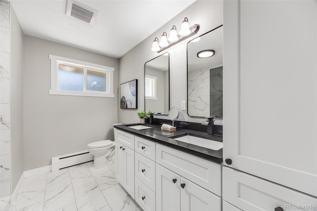 bathroom featuring vanity, a baseboard heating unit, and toilet