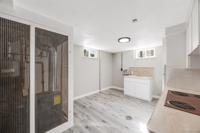 interior space with vanity, hardwood / wood-style floors, walk in shower, and decorative backsplash