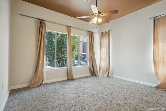 carpeted spare room featuring ceiling fan and a healthy amount of sunlight