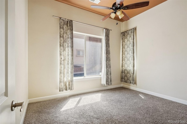 spare room with ceiling fan and carpet